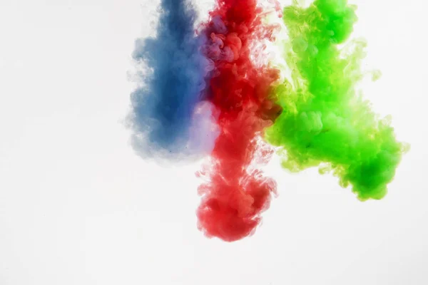 Green, red and blue colored abstract acrylic paint spraiyng on a — Stock Photo, Image