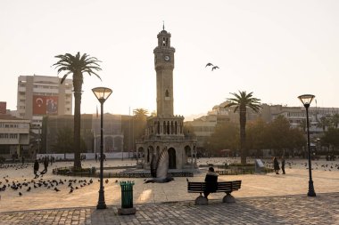 Clock tower and some people at Konak Square Izmir Turkey and in  clipart