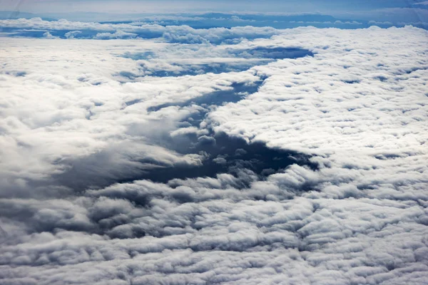 Clouds from a window of a commercial plane with sea. — Stock Photo, Image