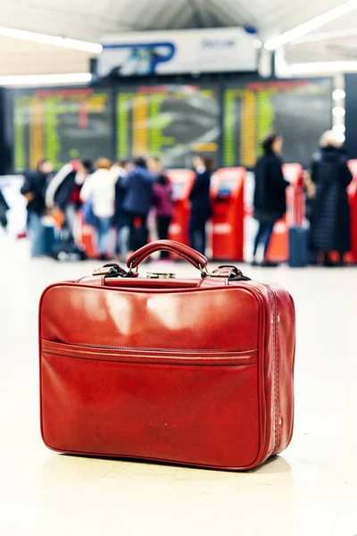 Rode tas staat op de vloer in een luchthaven. — Stockfoto