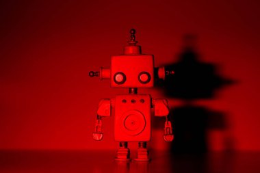 Kırmızı arka plan üzerinde robot.