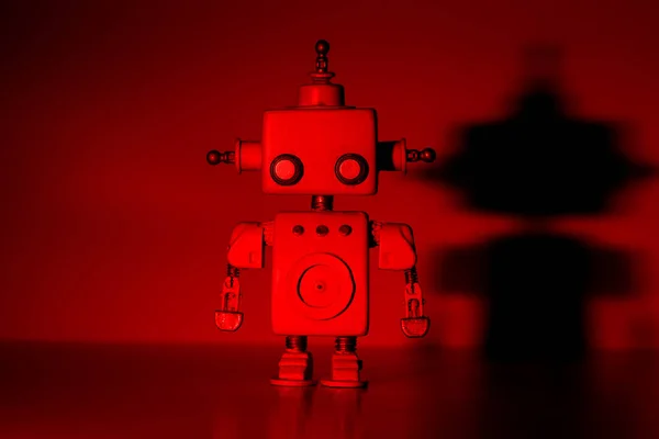 Robot pe un fundal roșu . — Fotografie, imagine de stoc