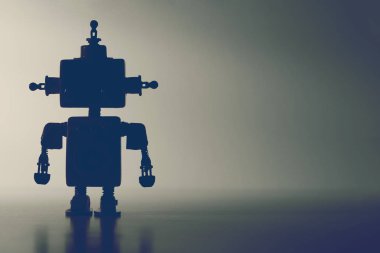 Gri arka planda sevimli bir robotun silüeti..