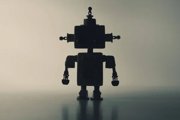 Silhouette of a cute robot on a gray background. — Stockfoto