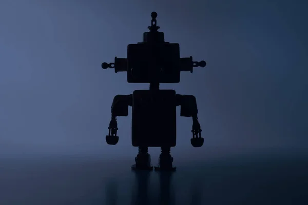 Silhouette of a cute robot on a blue background.