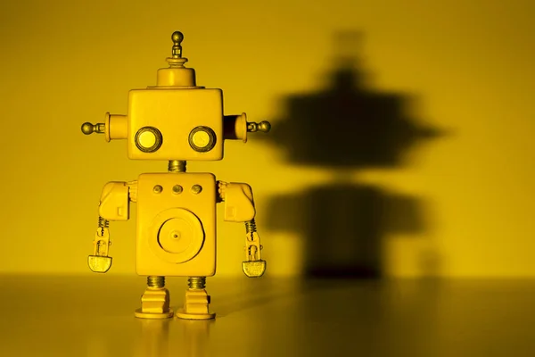 Robot on a yellow background. — Stock Photo, Image