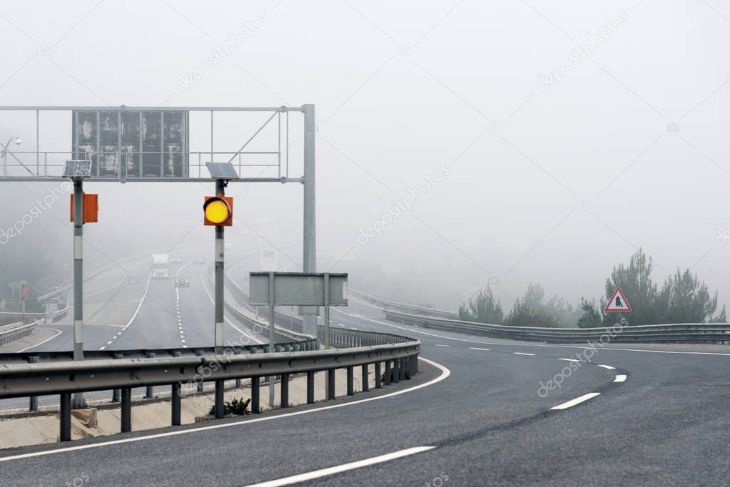 Bending road on Highway with fog in the morning.