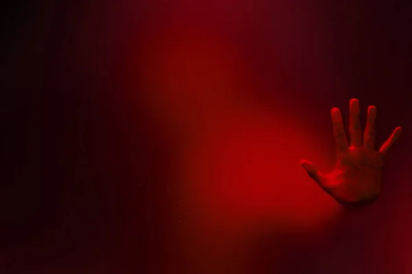 Creepy man holding the frosted glass with one hand. — Stock Photo, Image