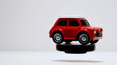 Izmir, Turkey - September 22, 2019. Rotating Red Toy car on a white background.