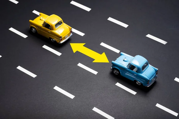 Two toy cars on the road one after another. — Stock Photo, Image