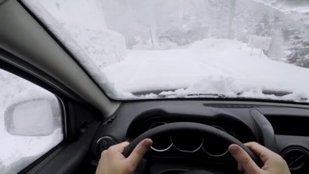 在雪地的道路上驾驶一辆汽车在暴风雪中行驶 — 图库视频影像