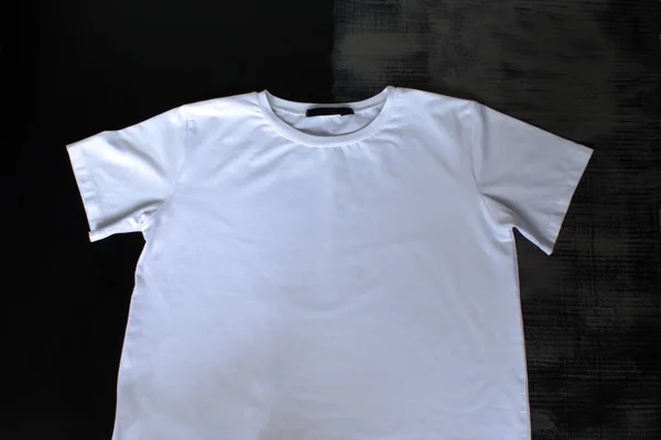 white t-shirt on a black-gray loft background with a place for a logo and brand name