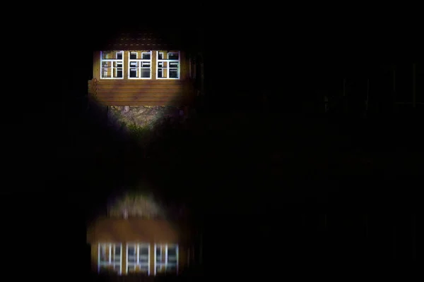 Windows Wooden House Island Searchlight Blurred Reflection Water Darkness Night — Stock Photo, Image