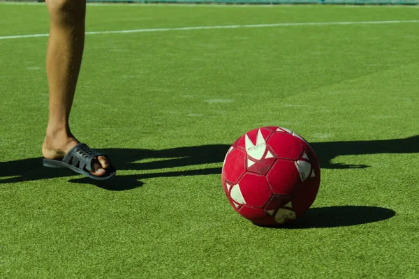 teenager feet playing with soccer ball on green field cover