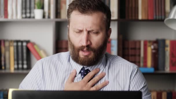 Trouble breathing, chest pain. Close-up of working bearded man, he has difficulty breathing or chest pain, touches his chest with hand. Heart attack, thoracic osteochondrosis, panic attack concept — Stock Footage Trouble breathing, chest pain. Close-up of working bearded man, he has difficulty breathing or chest pain, touches his chest with hand. Heart attack, thoracic osteochondrosis, panic attack concept Video Clip