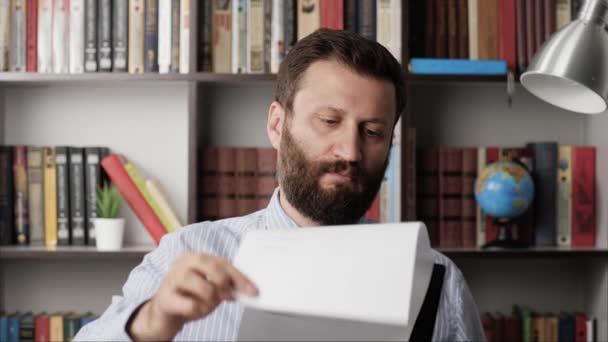 Focused male businessman manager at workplace is looking at some documents. Close-up — Stock Video