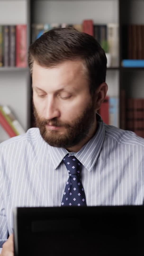 Man drinking alcohol. Vertical view bearded man at workplace pours whiskey brandy bourbon tape into glass and drinks. Depression, alcohol addiction, alcoholic, hangover, celebration concept. Close-up — Stock Video