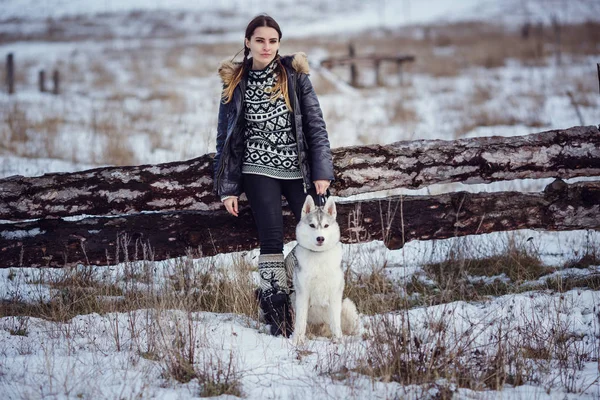 female hiker with siberian husky dog in park