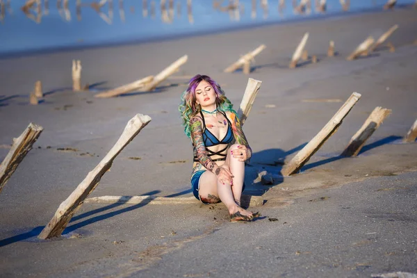Sexy Frau auf dem Sand neben einem See mit rosa Wasser — Stockfoto