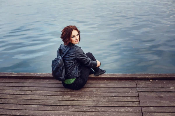 Young stylish woman wearing black coat, pants and handbag walkin — Stock Photo, Image