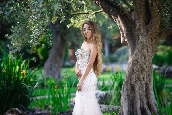 Fashion outdoor photo of elegant beautiful woman with blond hair in luxurious sequins dress and silver accessories,posing in summer park — Stock Photo, Image