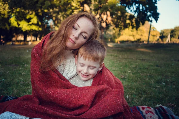 A series about happy red-haired. The elder sister and younger brother and sister. Park, autumn, river — Stock Image A series about happy red-haired. The elder sister and younger brother and sister. Park, autumn, river Royalty Free Stock Images