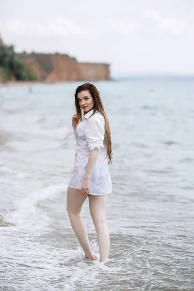 Donna vestita di bianco rinfrescante al mare — Foto Stock