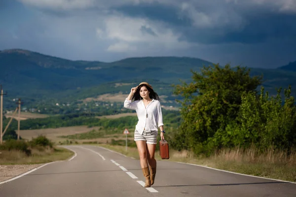 Smiling cheerful girl breathes a full breast and enjoys freedom