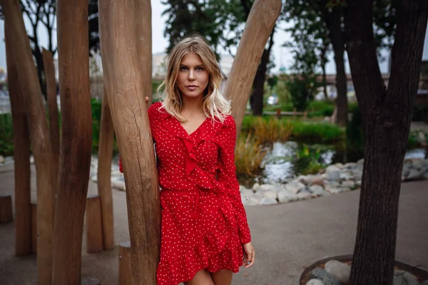 A beautiful young blonde woman walks in the center of Moscow.