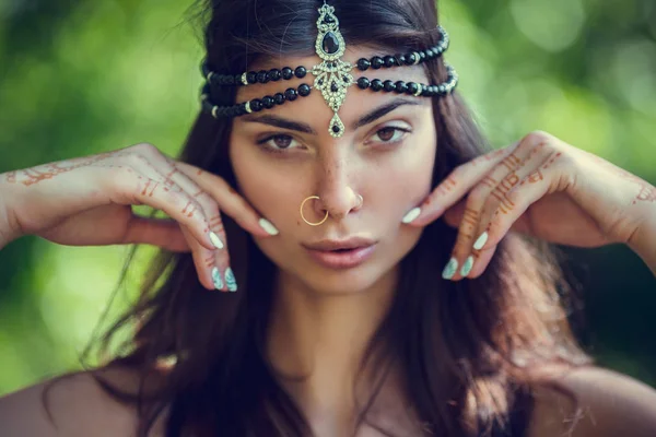 Drawing mehndi by means of henna on hands and a back of the girl. — Stock Photo, Image