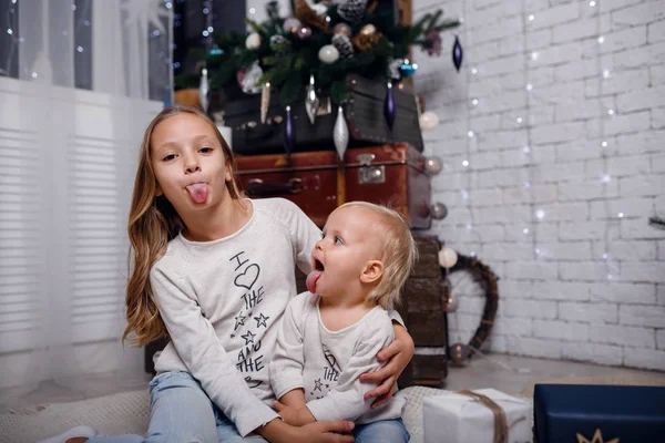 Crianças debaixo da árvore de Natal com caixas de presente. Decorações de Ano Novo . — Fotografia de Stock