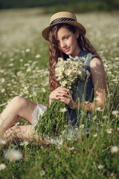 Menina em um campo de flores de margarida — Fotografia de Stock