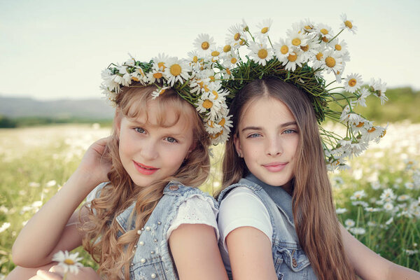 Little girl in a field of daisy flowers