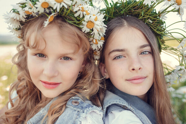 Little girl in a field of daisy flowers