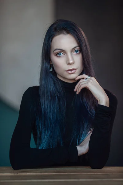Schöne junge Frau mit schwarzem Rollkragen posiert in einem stilvollen Zimmer — Stockfoto