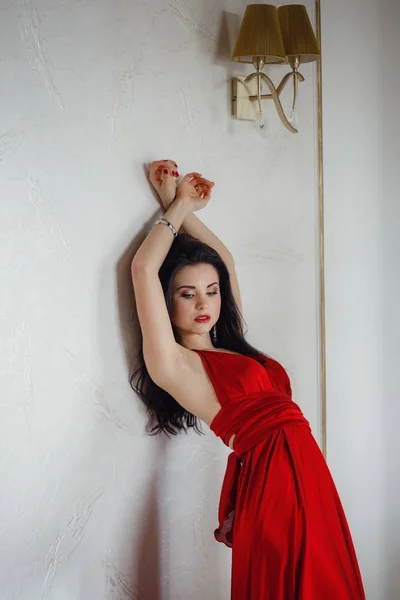 Hermosa mujer sexy en vestido rojo mirando posando feliz . — Foto de Stock