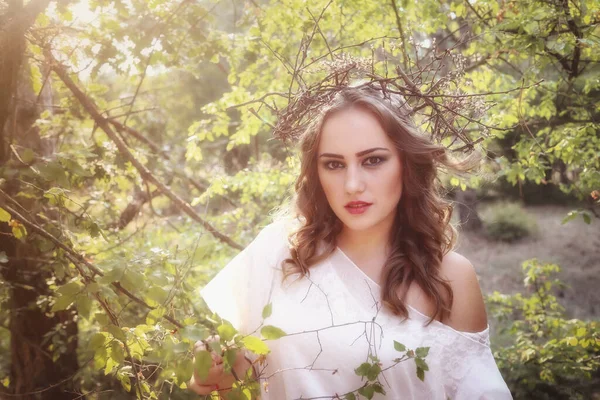 Beautiful mystery gothic woman in long white dress in autumn forest. Dark fantasy creature