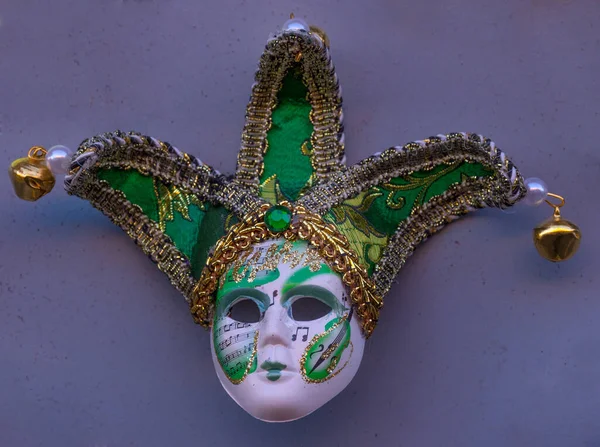 Traditional Venetian mask on the streets of Venice, Italy, isolated on colorful background.