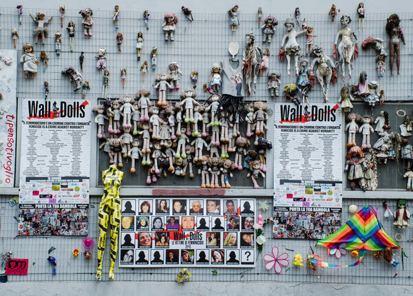 Milan/Italy-July 10, 2019: "The Wall of Dolls", a public art installation to highlight violence against women, became a monument as well to remember the female victims of domestic violence