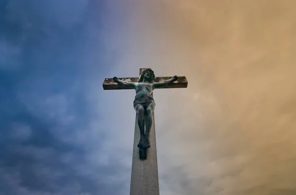 Jesus Christ on the cross against dramatic cloudy sky