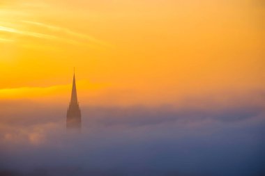 İsa 'nın Kutsal Kalbi Kilisesi gün doğumunda Avusturya' nın Graz bölgesinde sis ve bulutlarla çevrilidir. Graz şehrinde güzel sisli bir sabah, sonbaharda.