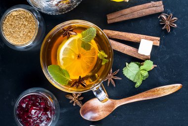 Sonbahar, limonlu çay ısınma bir cam bardak ve Ahududu reçeli siyah bir zemin üzerine nane. kopya alanı,