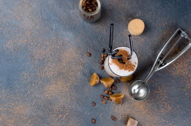 Sütlü çikolata kokteyl veya soğuk sütü ve buz ile çırpılmış kahve koyu arka plan üzerinde kopya alanı kakao serpin, 