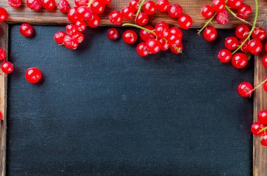 Olgun taze kırmızı kuş üzümü meyveleri koyu rustik arka üst görünümünde, kopya alanı