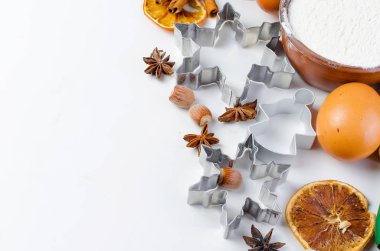 Yumurta, dahil olmak üzere Noel pişirme için malzemeler un kase, elek, hamur, tereyağı, kahverengi şeker, oklava, tarçın, baharatlar, çerez şekilleri, Gaze, anason, metin veya yemek tarifleri için yer boş eski beyaz tablo