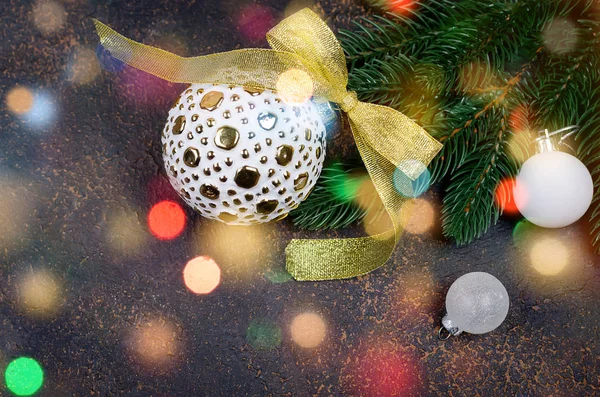 Christmas decorative background with gold and white christmas  gifts, ball and toys, fir branches, cones on the black background. card Holiday Concept. copy space, top view,