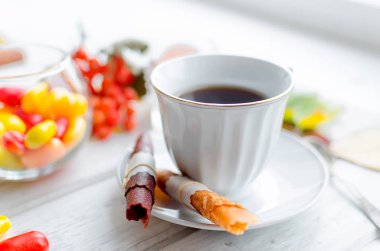 kahve ve meyve deri beyaz fincan rulo ve doğal ışık, seçici odak beyaz tahta masada kahvaltı fişleri,