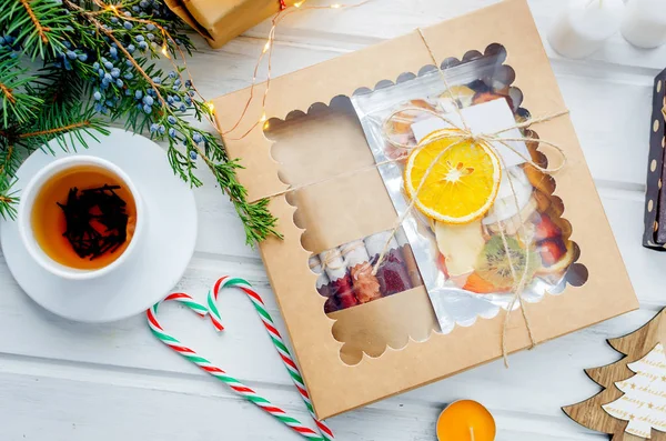 warming Tea and  gift box with Many variety of dry  fruit chips and fruit leather rolls on white background in the winter Christmas day, Holidays concept. Detox concept. Healthy food, Fruits amazing candy. selective focus,