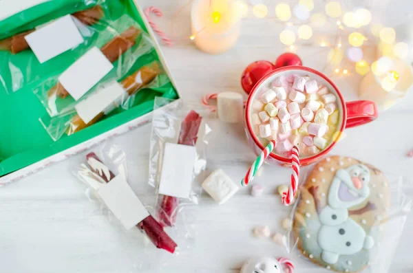 warm traditional  cocoa with marshmallows  in the winter Christmas day with gingerbread, fruit chips, fruit leather rolls and gifts on white background, copy space, Holidays concept.