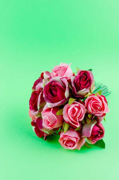 beautiful bouquet of red and dark pink roses on a green background, holiday concept, copy space